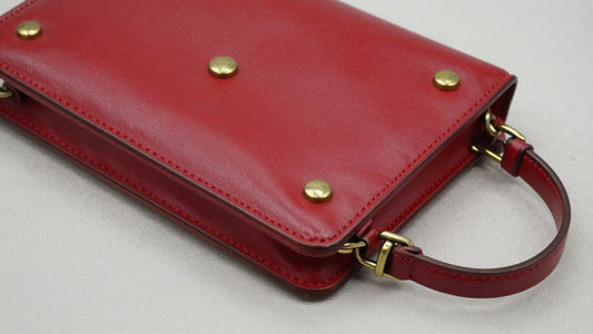 Vintage red purse with brass hardware.