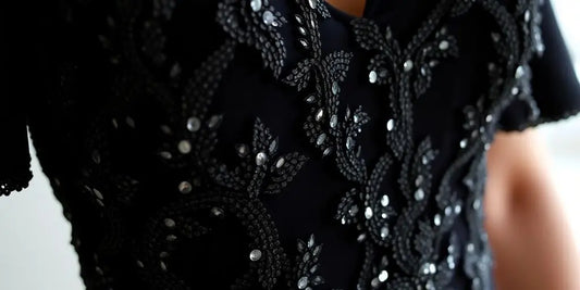 Sparkly black dress shimmering under soft light.